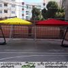 سایه بان باغی مدل پایه کنار در حیاط مدرسه در رنگ زرد و قرمز چترباغی شیک